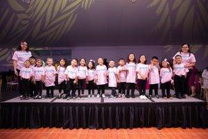 03 student performers at elevate pose for a group photo while rehearsing for elevate